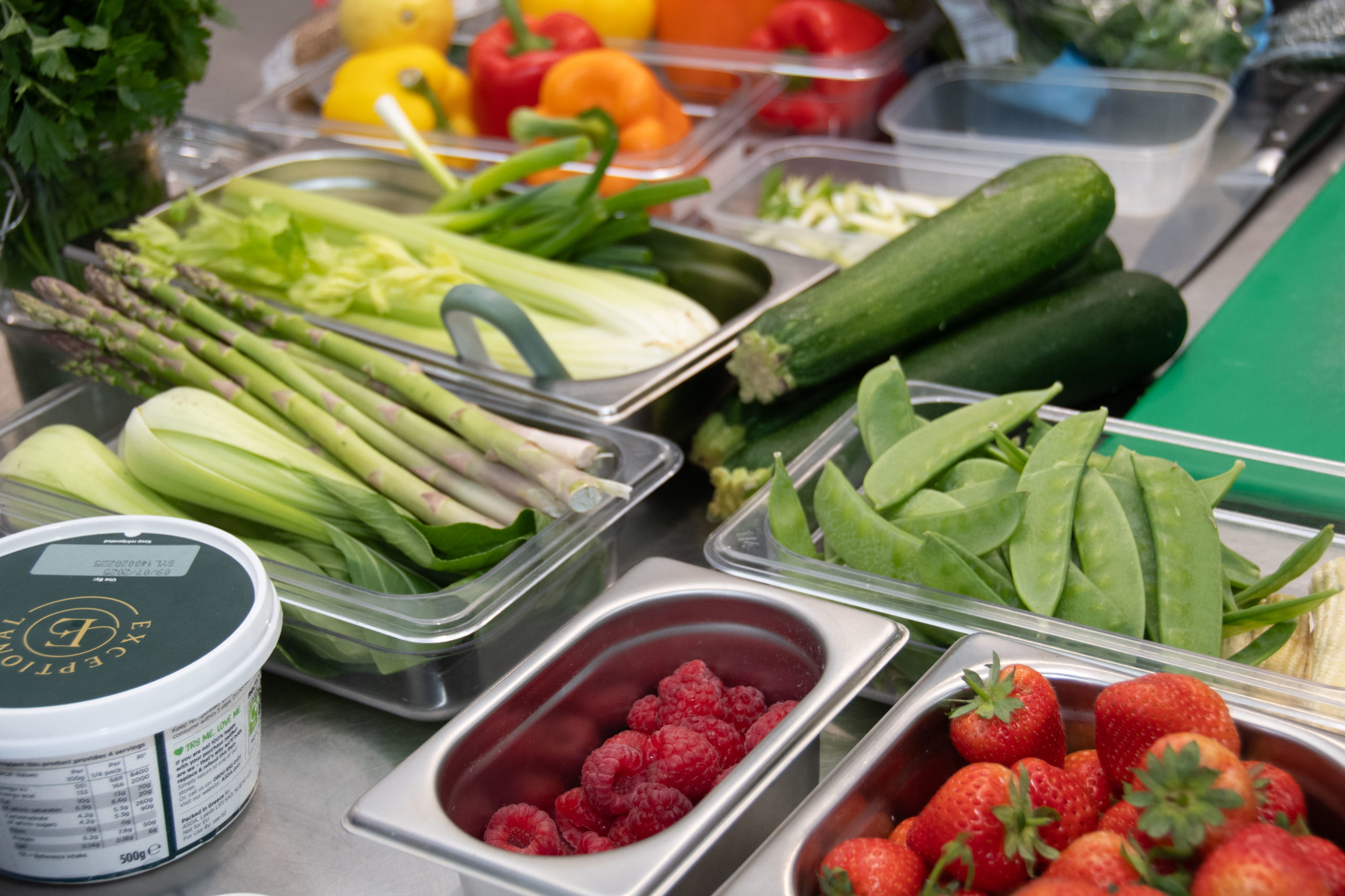 An array of green vegetables and fruit ready for low carb demo