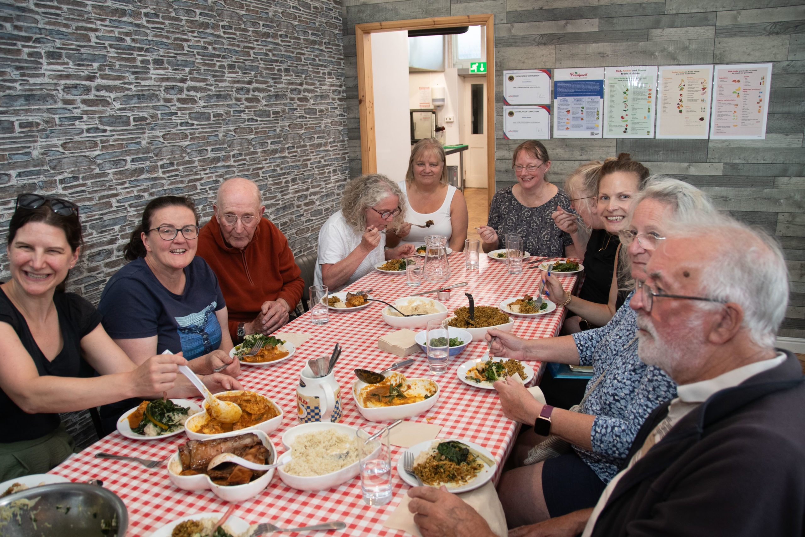 Low carb group sitting around farm house table eating what they have cooked