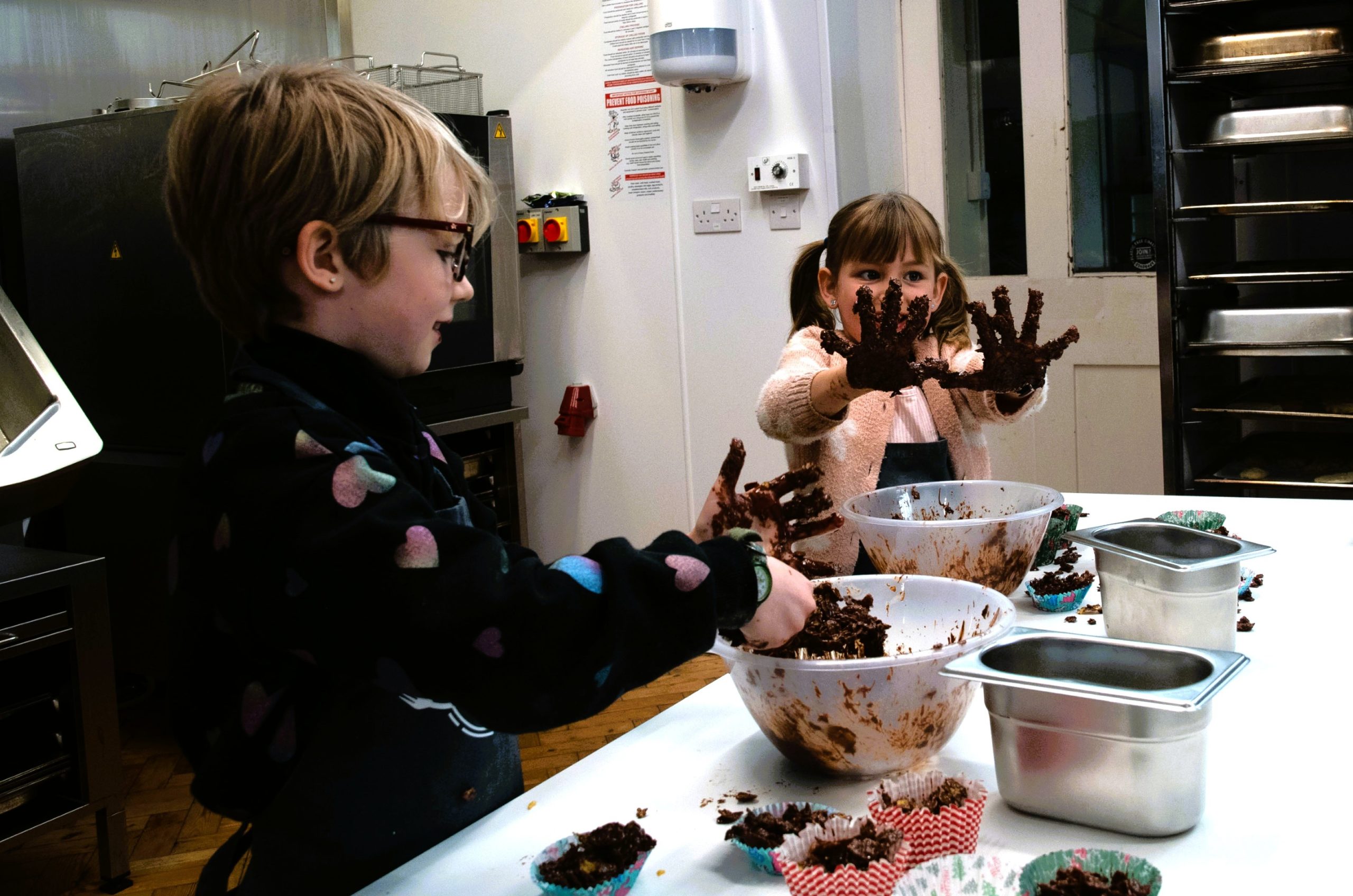 Children with chocolate covered hands at Hands On Cookery School